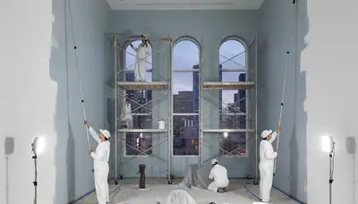 Commercial painting crew applying durable exterior coating to a St. Louis, MO business building